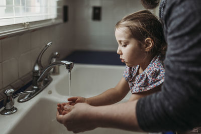 Close-up of woman in bathroom at home