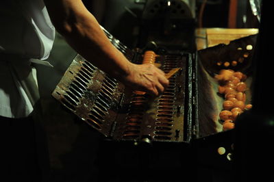 Midsection of man playing piano