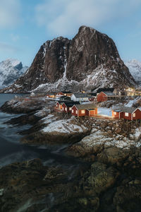 High angle view of houses by lake against mountain