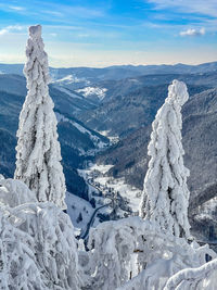 Scenic view of snow covered mountains against sky