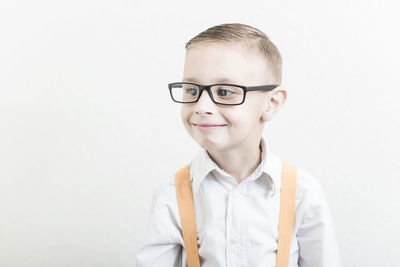 Portrait of young man standing against white background