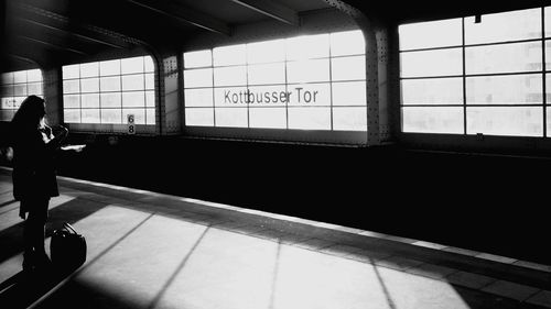 Side view of woman standing at kottbusser tor station
