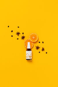High angle view of orange on table against yellow background