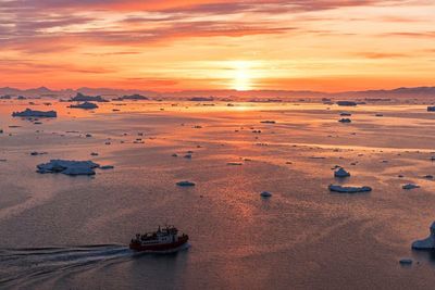 High angle view of boats in sea at sunset