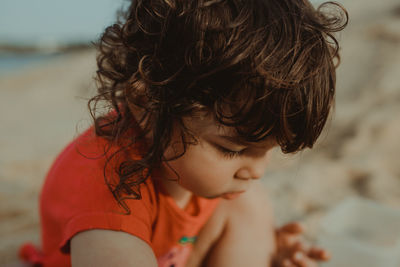 Close-up of cute girl playing on beach