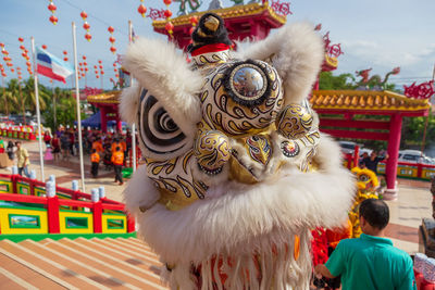 Close-up of dragon in traditional clothing against sky