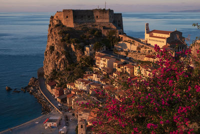 High angle view of buildings by sea