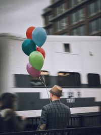 Rear view of man with balloon balloons