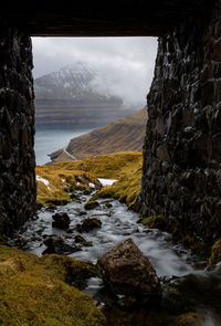 Scenic view of streaming water under the bridge