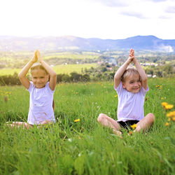 Full length of mother and daughter on field