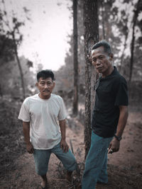 Portrait of a smiling young man in forest