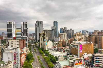 High angle view of street amidst buildings in city against sky