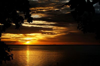 Scenic view of sea against orange sky