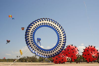 Low angle view of ferris wheel against sky