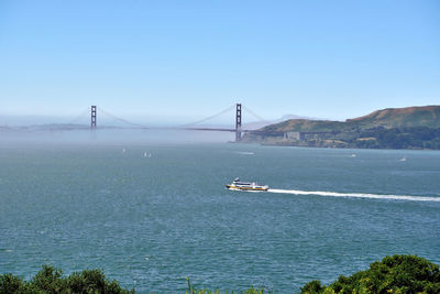 View of suspension bridge over sea