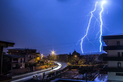 Lightning over illuminated city at night