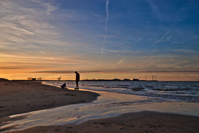 Scenic view of beach against sky during sunset