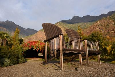 Chairs on mountain against sky