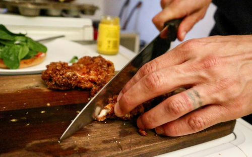 Close-up of man preparing food on cutting board