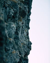 Low angle view of rocks against clear sky