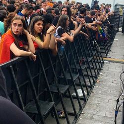 High angle view of young woman using mobile phone outdoors