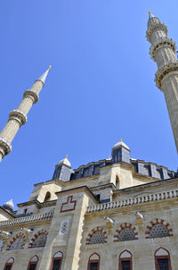 Low angle view of building against clear blue sky