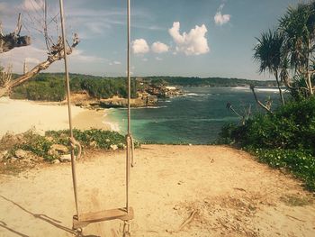 Scenic view of calm sea against cloudy sky