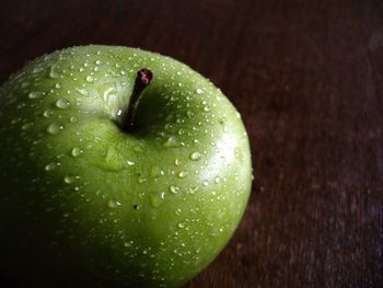 Close-up of fresh green apple on table