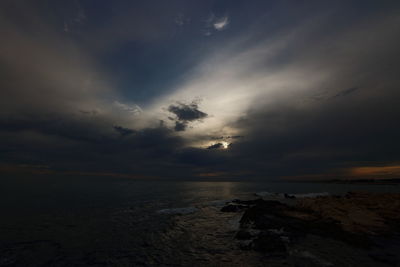 Scenic view of sea against storm clouds