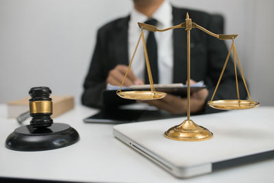 Close-up of person holding electric lamp on table