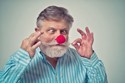 Portrait of man wearing mask against gray background