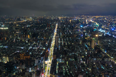 High angle view of city lit up at night