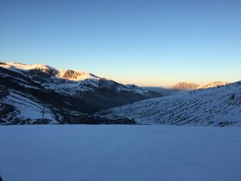 Scenic view of snow covered mountains against clear sky