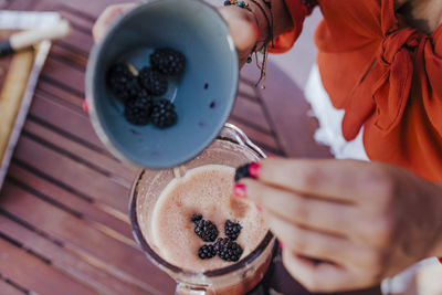 Midsection of woman holding ice cream