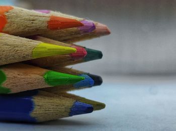 Close-up of multi colored pencils on table