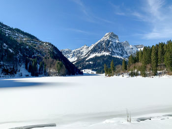 Scenic view of snowcapped mountains against sky