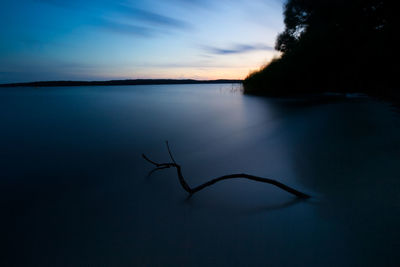 Scenic view of lake against sky at sunset