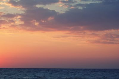 Scenic view of sea against orange sky