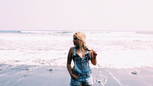 Rear view of woman standing on beach