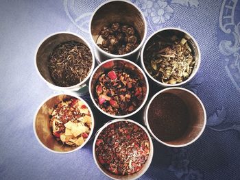 Directly above shot of raw tea leaves in jars