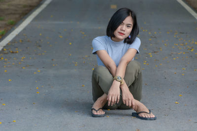 Portrait of young woman sitting outdoors