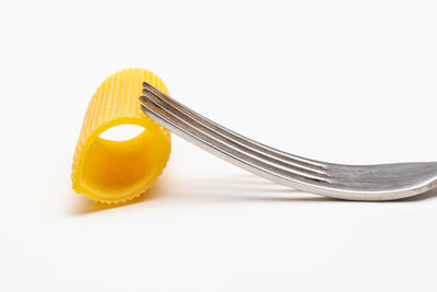 Close-up of fork on table against white background