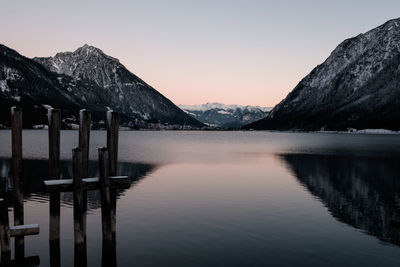 Scenic view of lake and mountains against sky during sunset