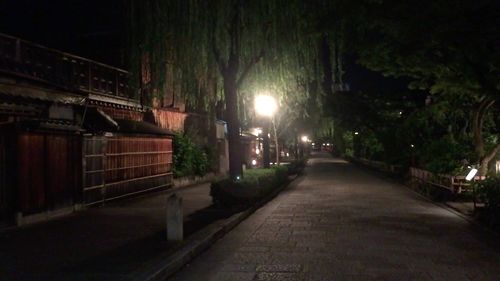 Illuminated walkway at night