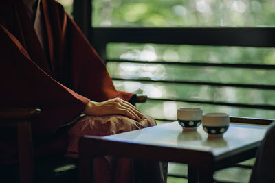 Midsection of woman reading book