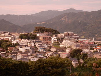 High angle view of townscape and mountains against sky