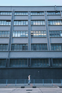 Low angle view of woman standing against building