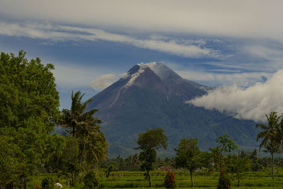 Panoramic view of merapi volcanic mountain against cloudy sky