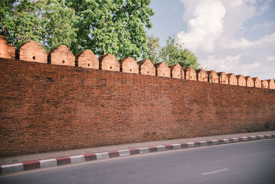 View of brick wall by road