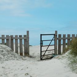 Built structure on beach against clear sky